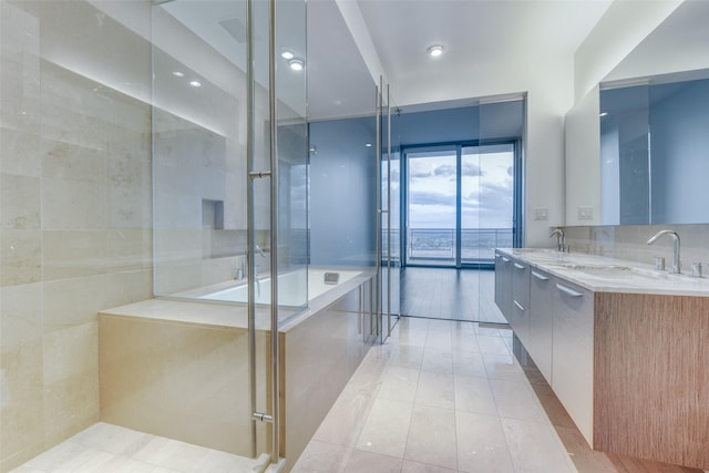 full bath with tile patterned floors, an enclosed shower, double vanity, and a sink