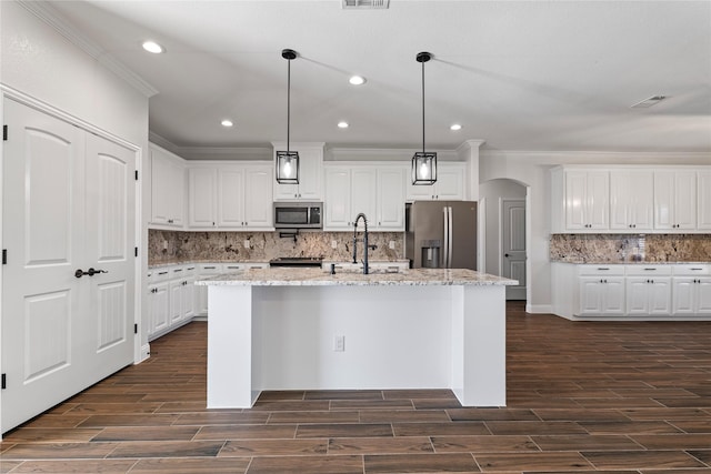 kitchen with white cabinetry, appliances with stainless steel finishes, and an island with sink