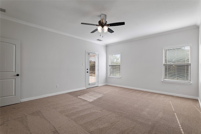 carpeted spare room featuring ceiling fan and ornamental molding