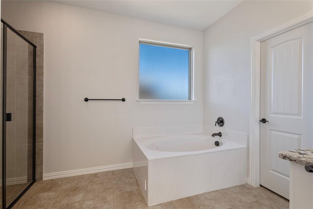 bathroom with separate shower and tub and tile patterned floors