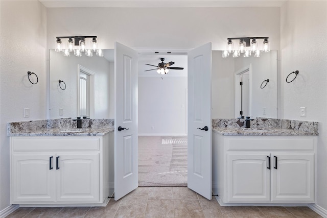 bathroom featuring ceiling fan, vanity, and tile patterned flooring