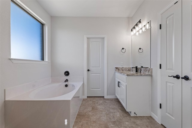 bathroom with vanity, tile patterned flooring, and a bathing tub