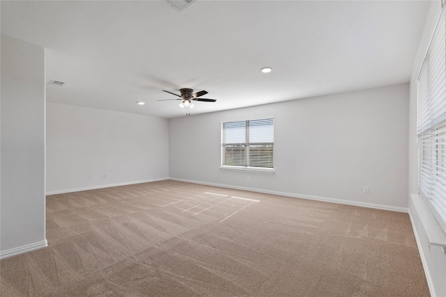 unfurnished room with light colored carpet and ceiling fan