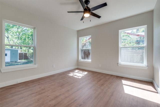 empty room featuring ceiling fan and light hardwood / wood-style flooring