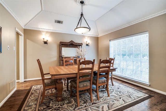 dining area with crown molding, dark hardwood / wood-style flooring, and vaulted ceiling