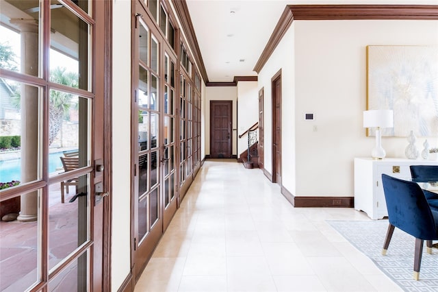 hall featuring crown molding, french doors, and light tile patterned flooring