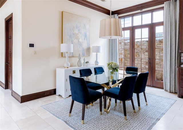 tiled dining area featuring crown molding