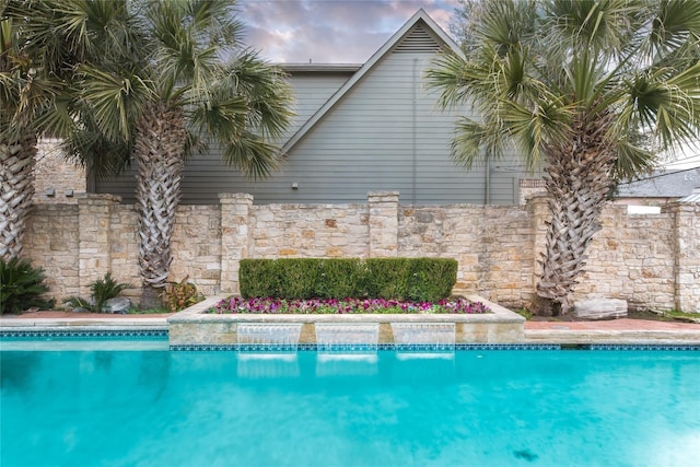 view of swimming pool featuring pool water feature