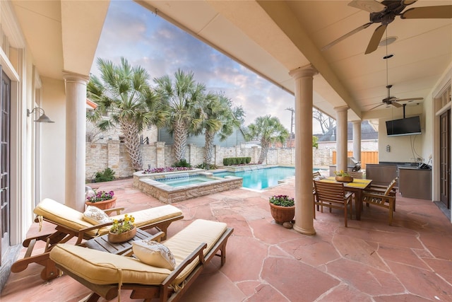 view of patio featuring a swimming pool with hot tub