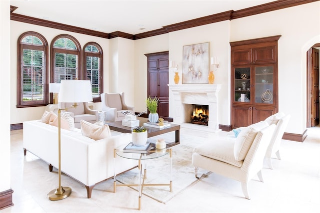 living room featuring a premium fireplace and crown molding