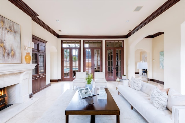 living room featuring ornamental molding, a high end fireplace, and french doors