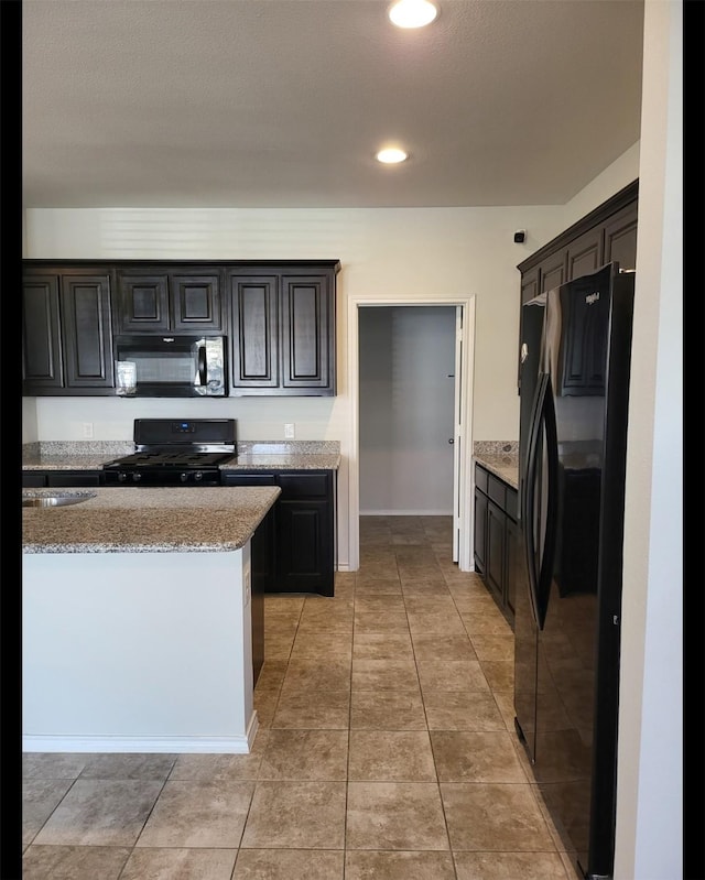 kitchen featuring light stone countertops, baseboards, light tile patterned flooring, recessed lighting, and black appliances