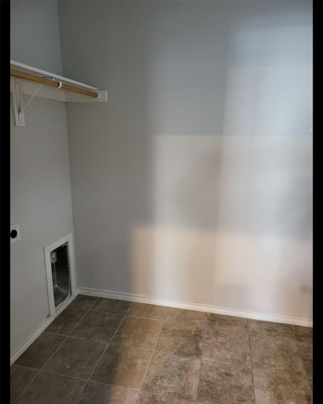 laundry area with laundry area, baseboards, and hookup for an electric dryer