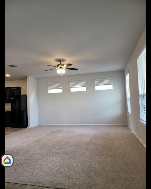 unfurnished room featuring carpet and ceiling fan