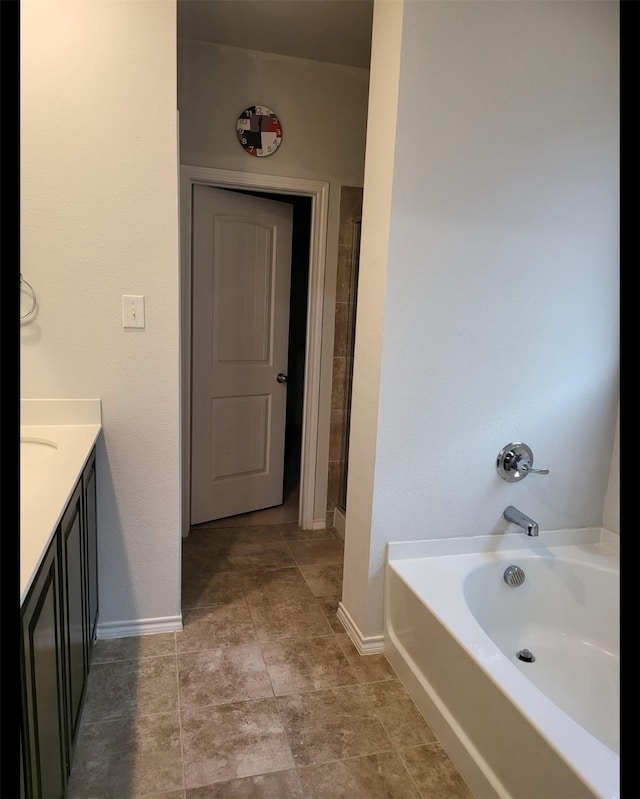 full bathroom with a shower with shower door, baseboards, a bath, and vanity