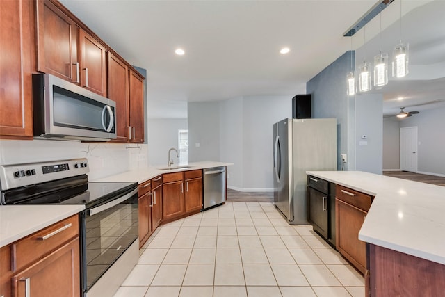 kitchen featuring sink, light tile patterned floors, pendant lighting, ceiling fan, and stainless steel appliances