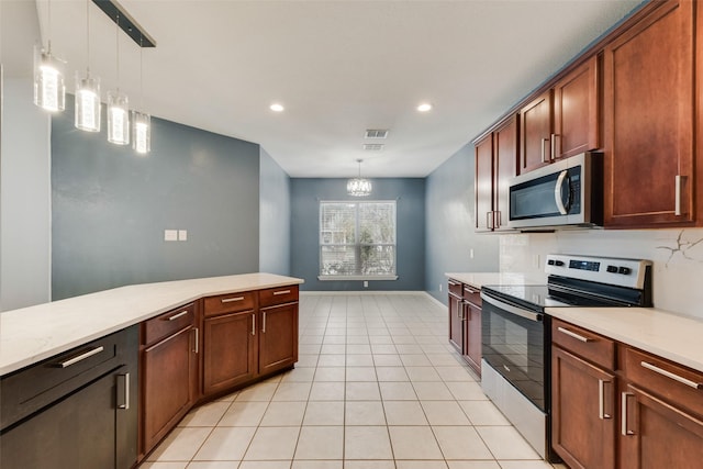 kitchen with appliances with stainless steel finishes, decorative light fixtures, a chandelier, and light tile patterned floors