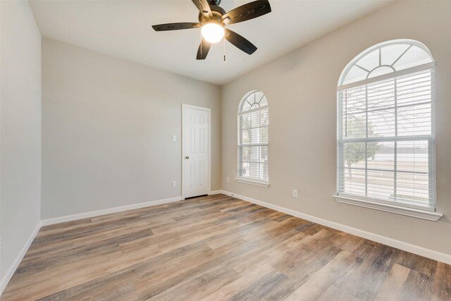 empty room featuring ceiling fan and light hardwood / wood-style floors