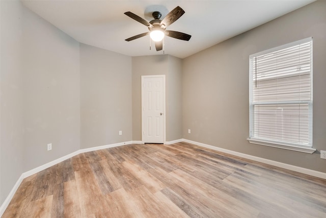 spare room featuring ceiling fan and light wood-type flooring