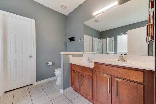 bathroom featuring tile patterned flooring, an enclosed shower, vanity, and toilet