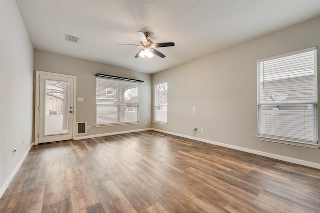 empty room with ceiling fan and hardwood / wood-style floors