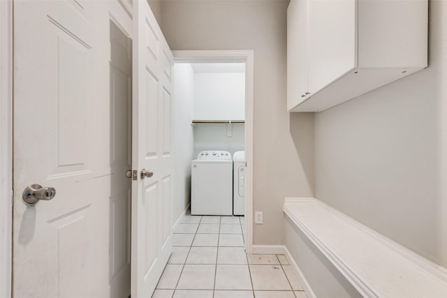 clothes washing area featuring light tile patterned floors and independent washer and dryer