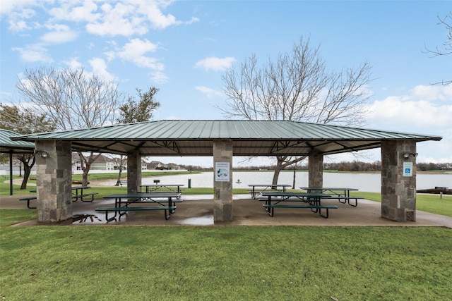 surrounding community featuring a gazebo, a water view, and a yard