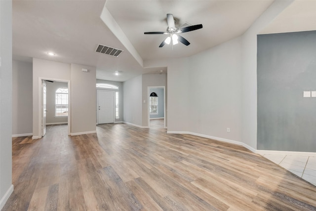 unfurnished living room featuring ceiling fan and light wood-type flooring