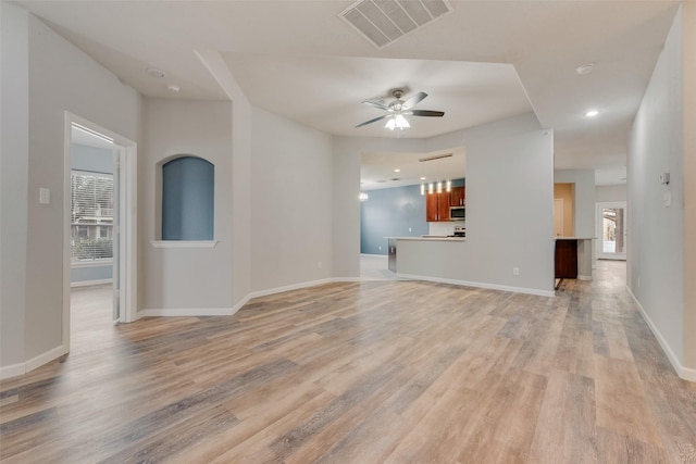 unfurnished living room with ceiling fan and light wood-type flooring