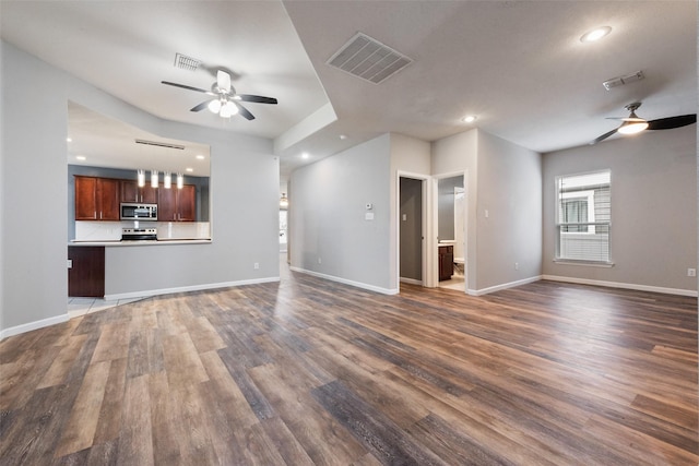 unfurnished living room with dark hardwood / wood-style floors and ceiling fan