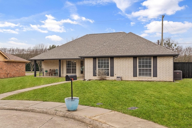 ranch-style home with a front yard and central air condition unit