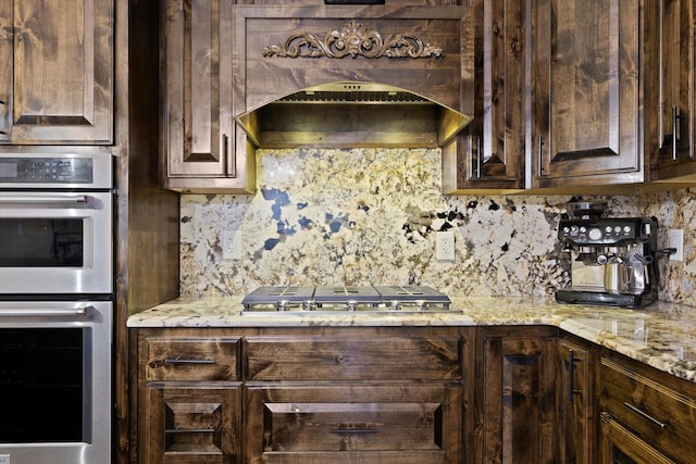 5401 Loftsmoor Ct, Fort Worth, TX 76244 - kitchen with stainless steel appliances, dark brown cabinets, tasteful backsplash, and light stone countertops