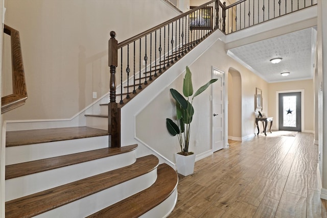 5401 Loftsmoor Ct, Fort Worth, TX 76244 - stairway featuring ornamental molding, wood finished floors, baseboards, and arched walkways