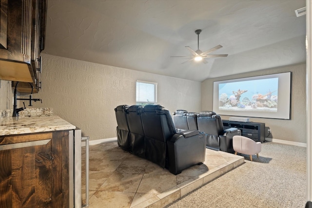 home theater featuring lofted ceiling and ceiling fan