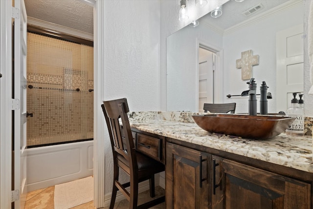 5401 Loftsmoor Ct, Fort Worth, TX 76244 - bathroom featuring crown molding, vanity, combined bath / shower with glass door, a textured ceiling, and a textured wall