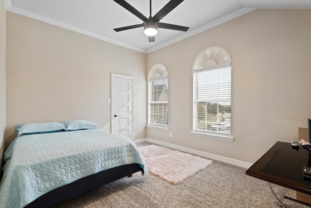 carpeted bedroom featuring vaulted ceiling, ornamental molding, and ceiling fan