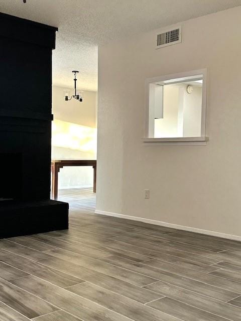 unfurnished room with a textured ceiling