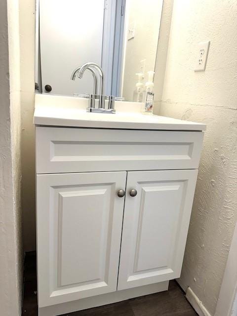 bathroom with vanity and hardwood / wood-style floors