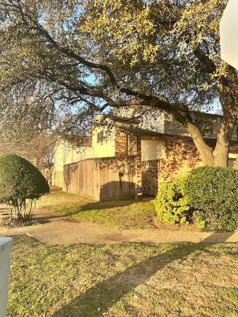 view of property exterior with a yard