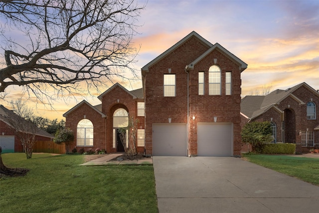 front facade featuring a garage and a lawn