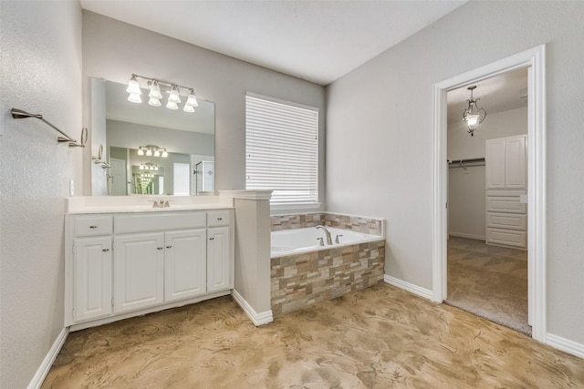 bathroom with vanity and tiled bath