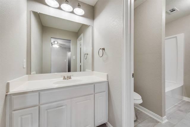 bathroom with ceiling fan, tile patterned floors, vanity, and toilet