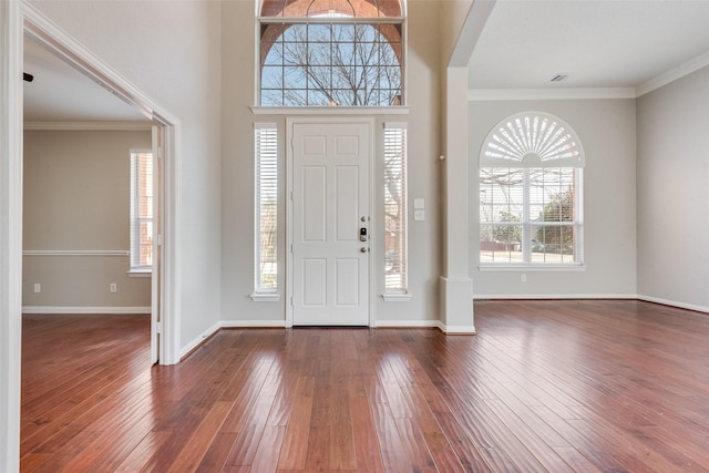 entrance foyer featuring dark hardwood / wood-style flooring and crown molding