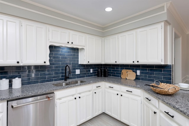 kitchen with white cabinetry, stainless steel dishwasher, light stone countertops, and sink