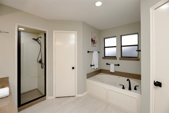 bathroom with separate shower and tub and hardwood / wood-style floors