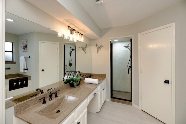 bathroom with vanity and a shower