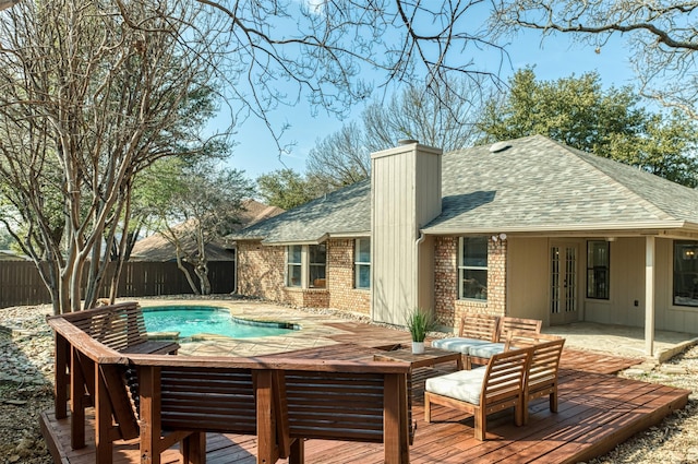 rear view of house featuring a pool side deck