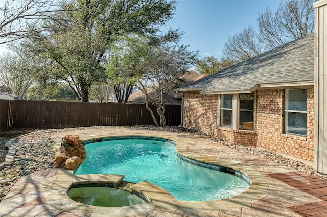 view of swimming pool featuring an in ground hot tub