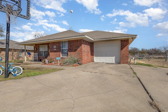 ranch-style house featuring a garage, brick siding, a shingled roof, fence, and concrete driveway