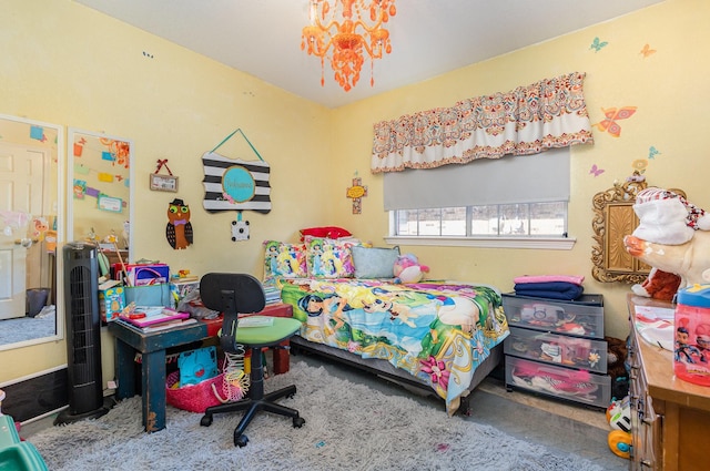 carpeted bedroom with a chandelier